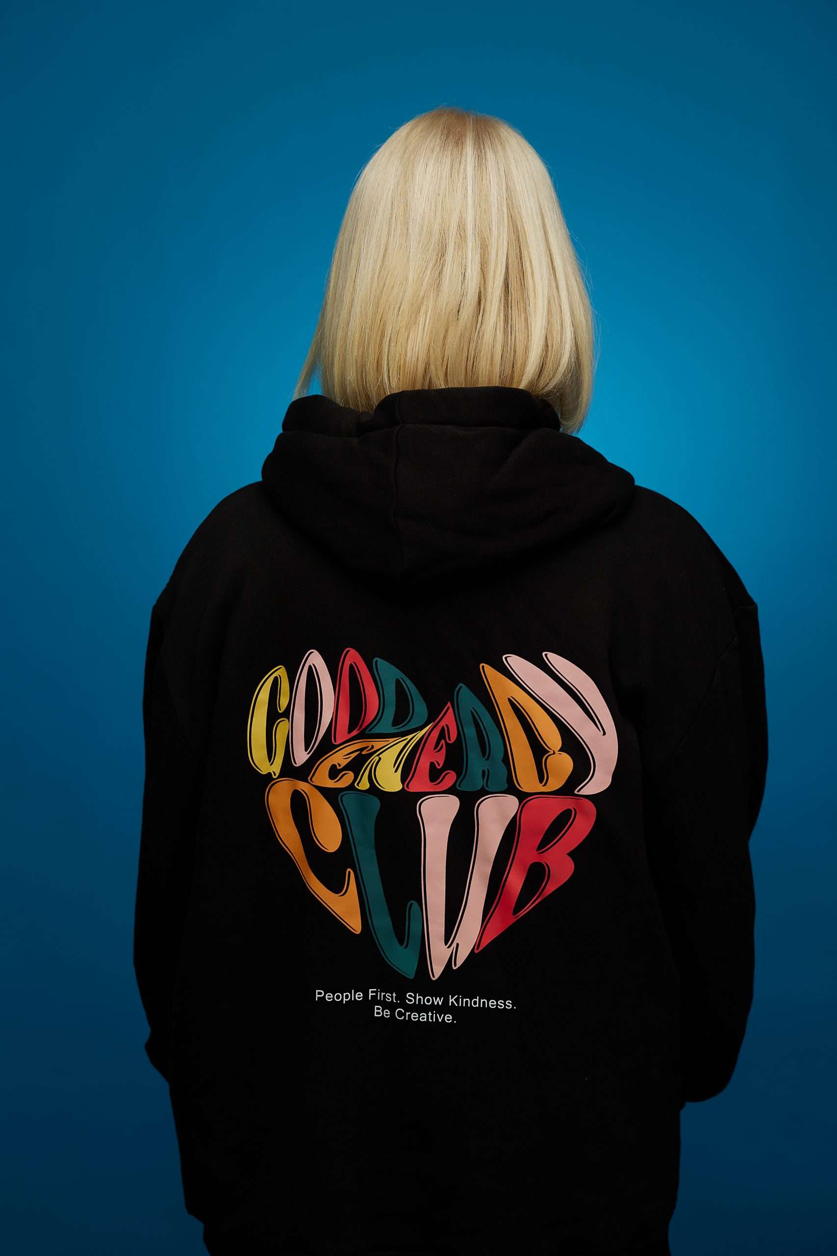An image of the read of a female wearing a Good Energy Club hoodie